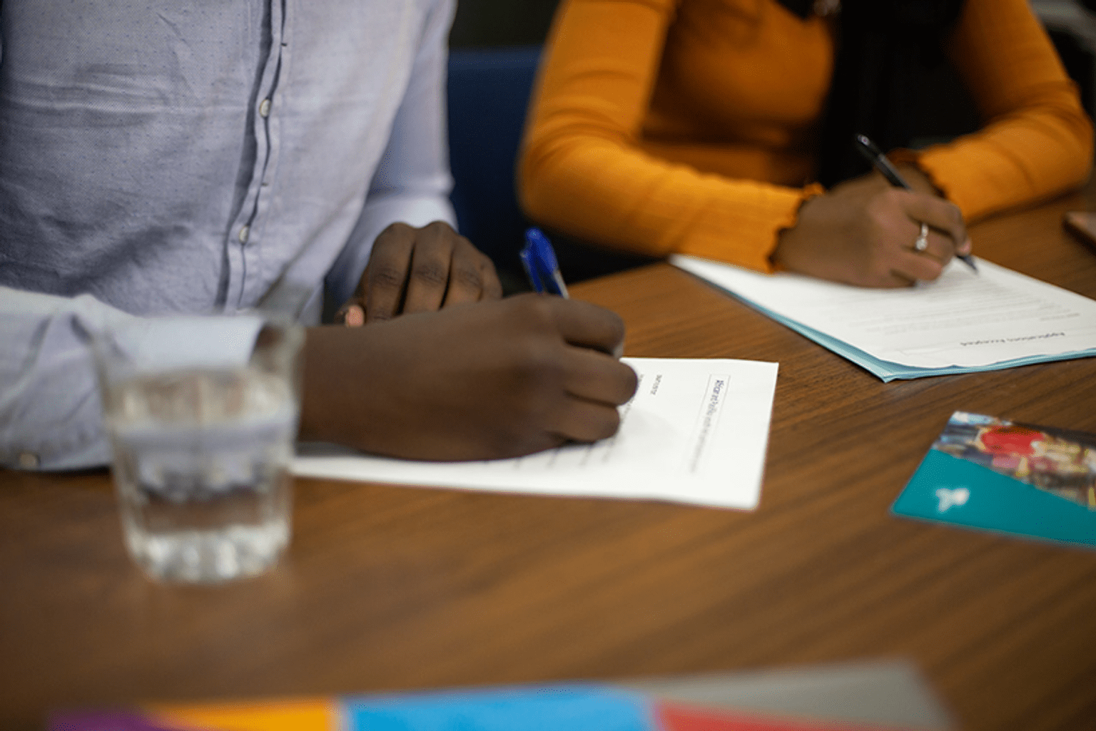 Two young people of African background writing at a desk Two young people of African background writing at a desk