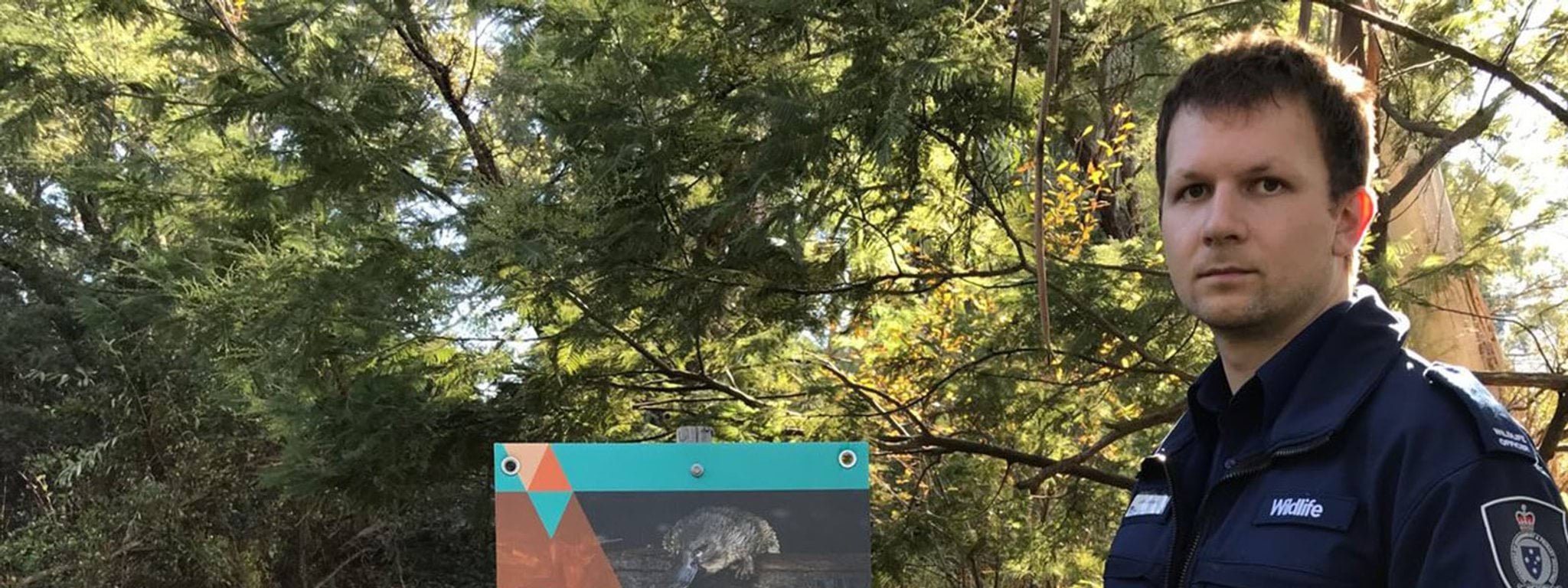 Our achievements Image of wildlife officer holding a platypus net