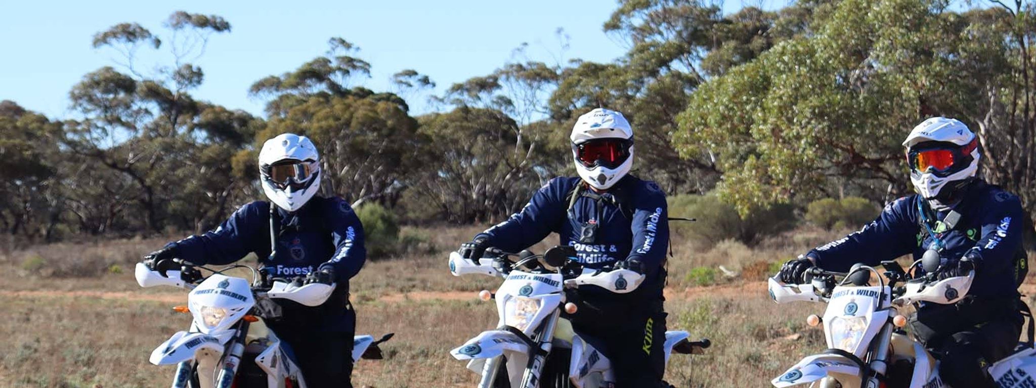 Contact us Image of wildlife officers on dirt bikes