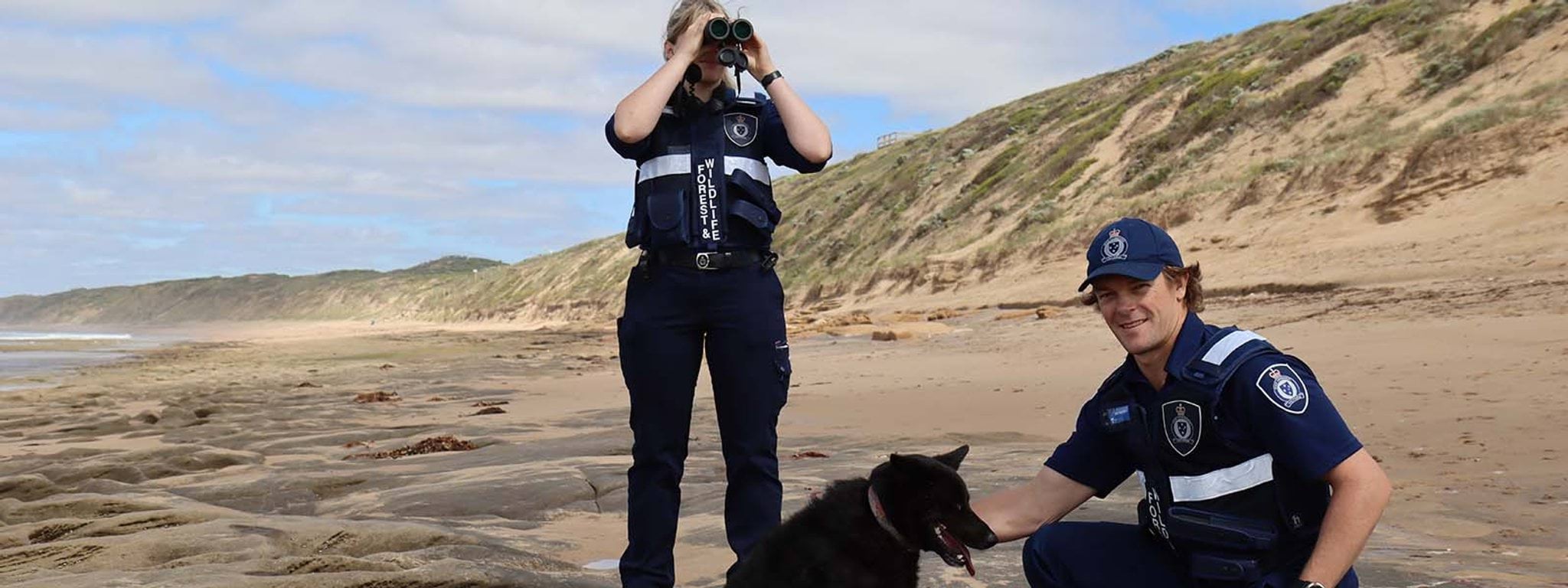 Conservation Regulator Victoria Year in Review 2020-21 Image of officers and a dog on a beach