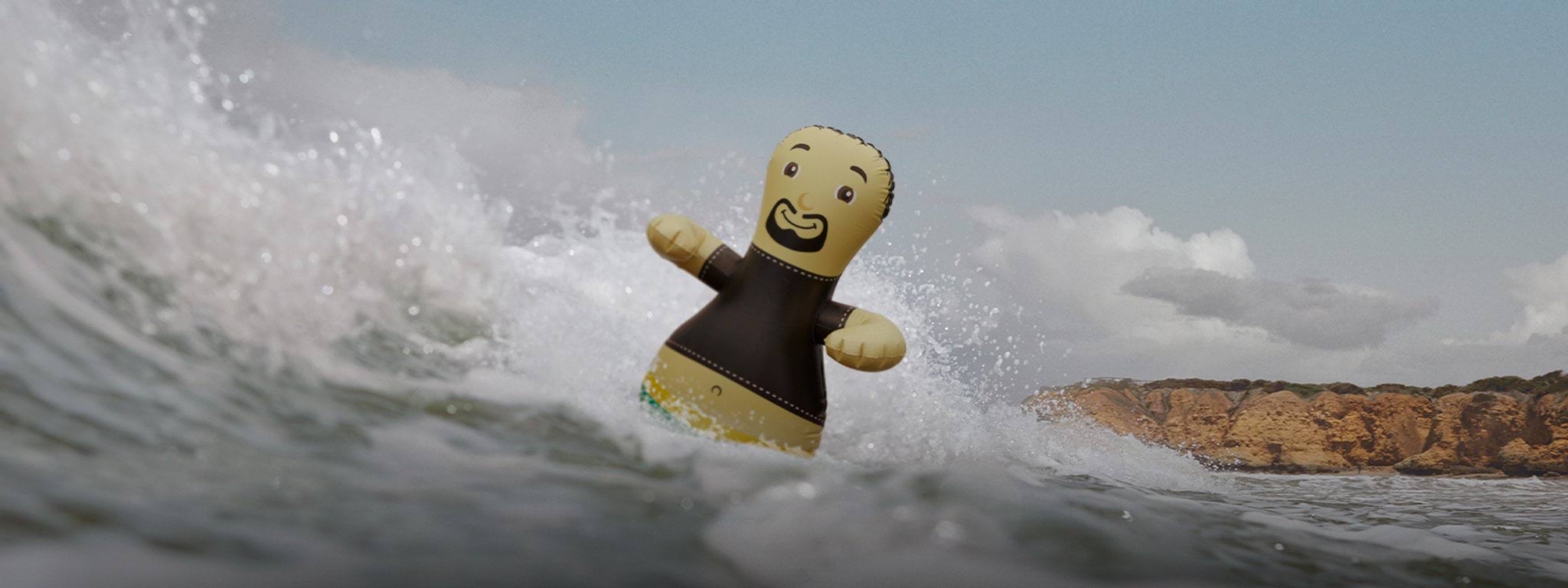 an inflatable man floating in the waves of a surf beach