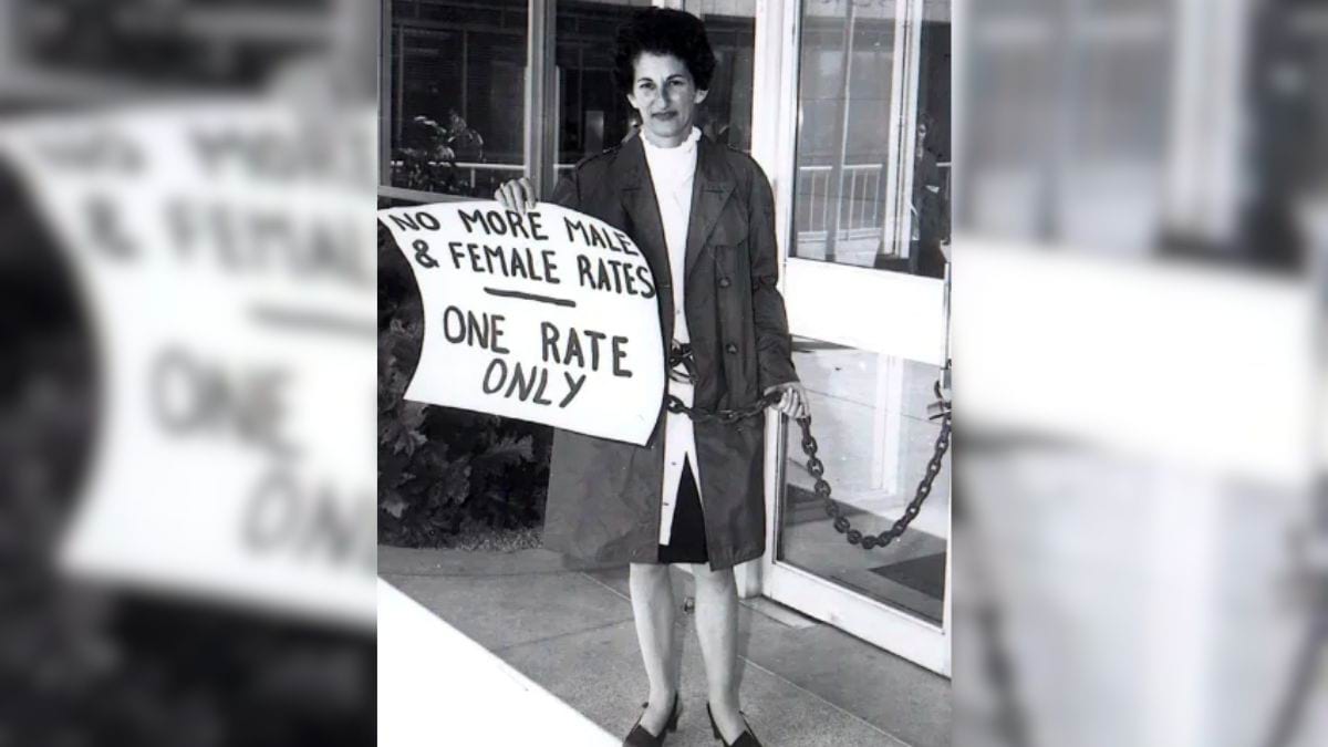 Photograph of Zelda D'Aprano chained to a courthouse. She is holding a sign that says