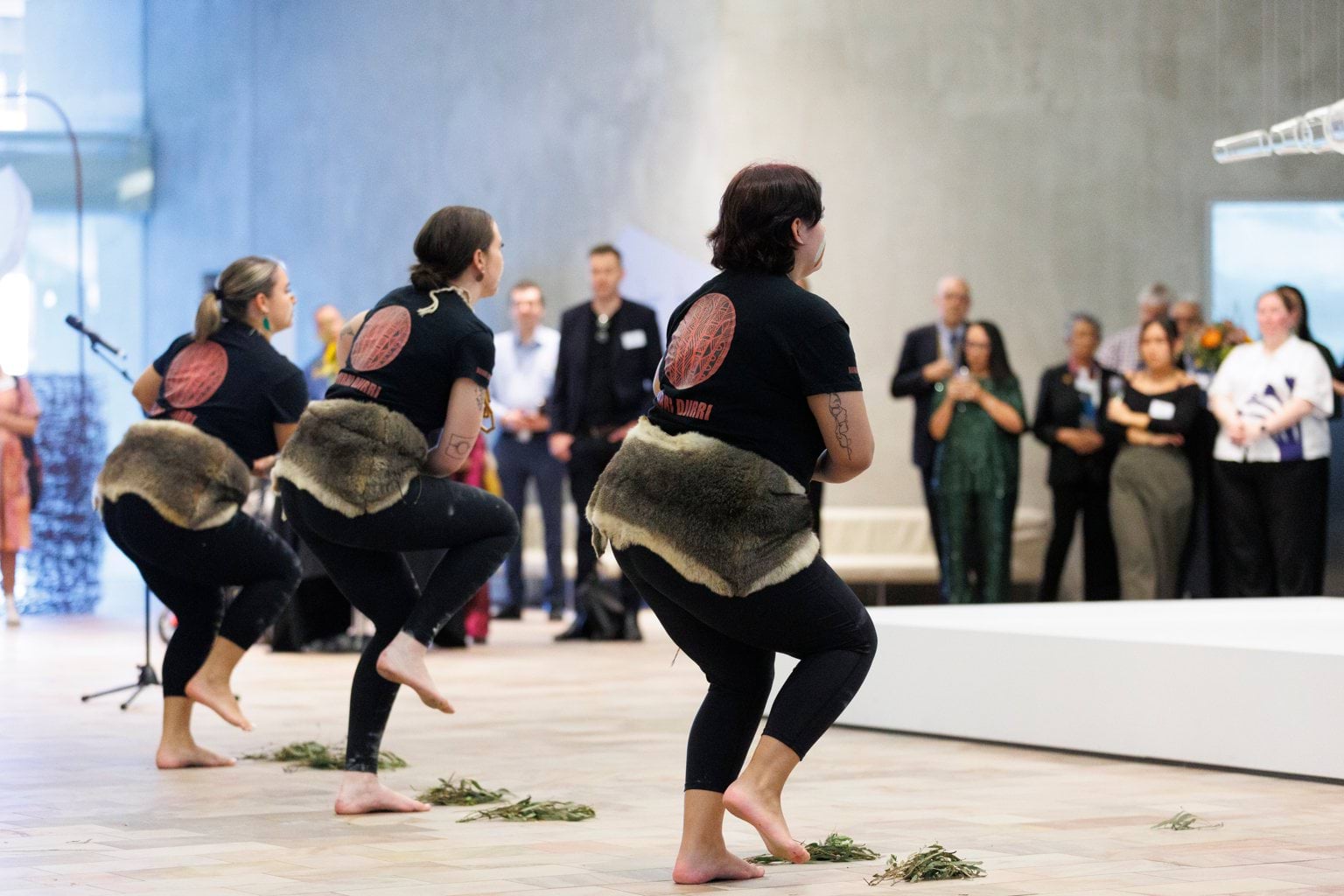 Closing the Gap welcome reception Three First Nations dancers in traditional dress