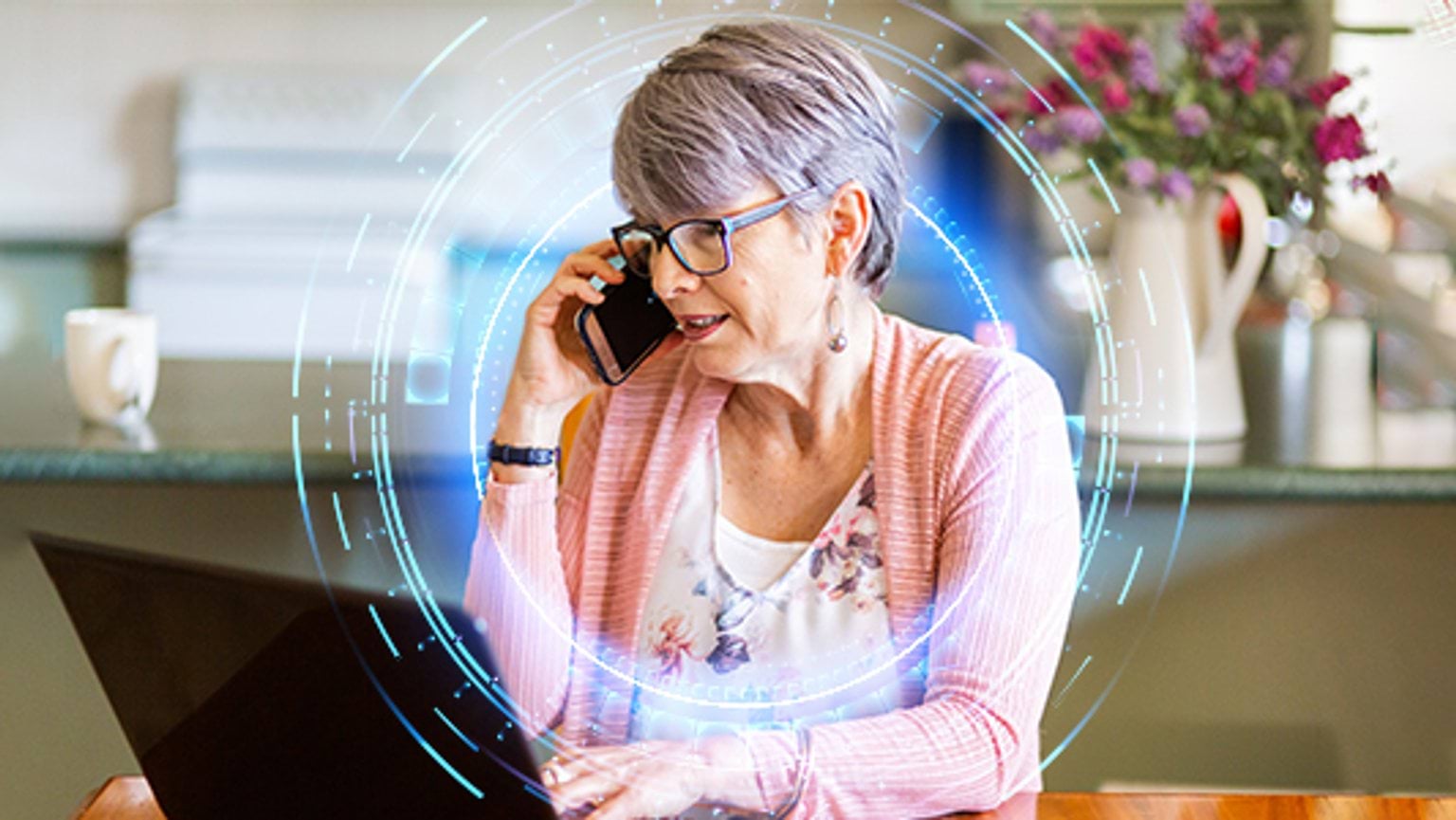 Woman using laptop and phone to get help following a cybersafety incident