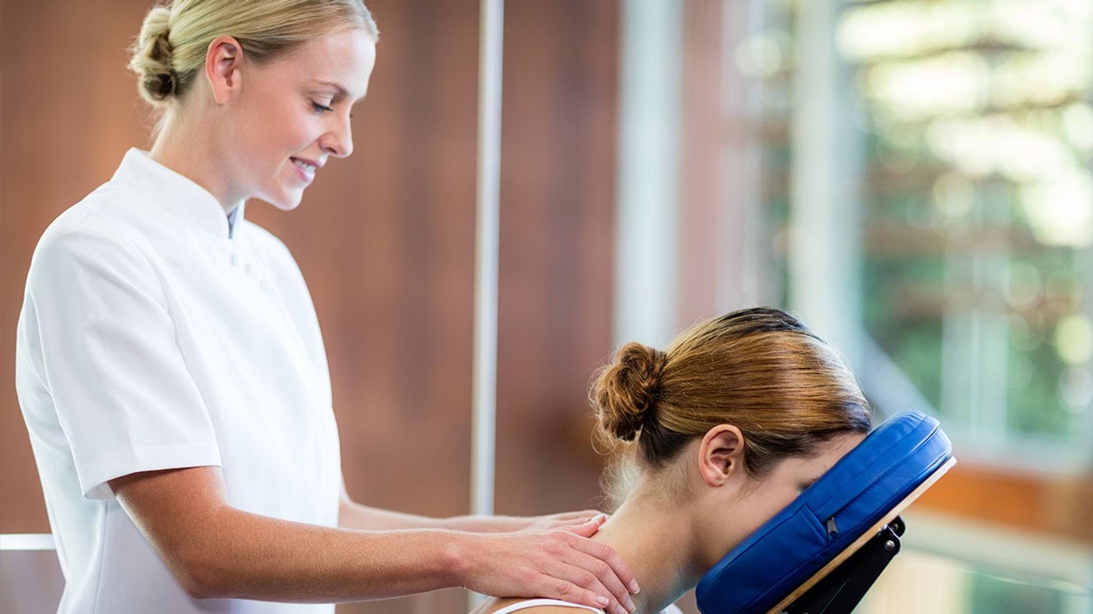 Massage therapist working on client