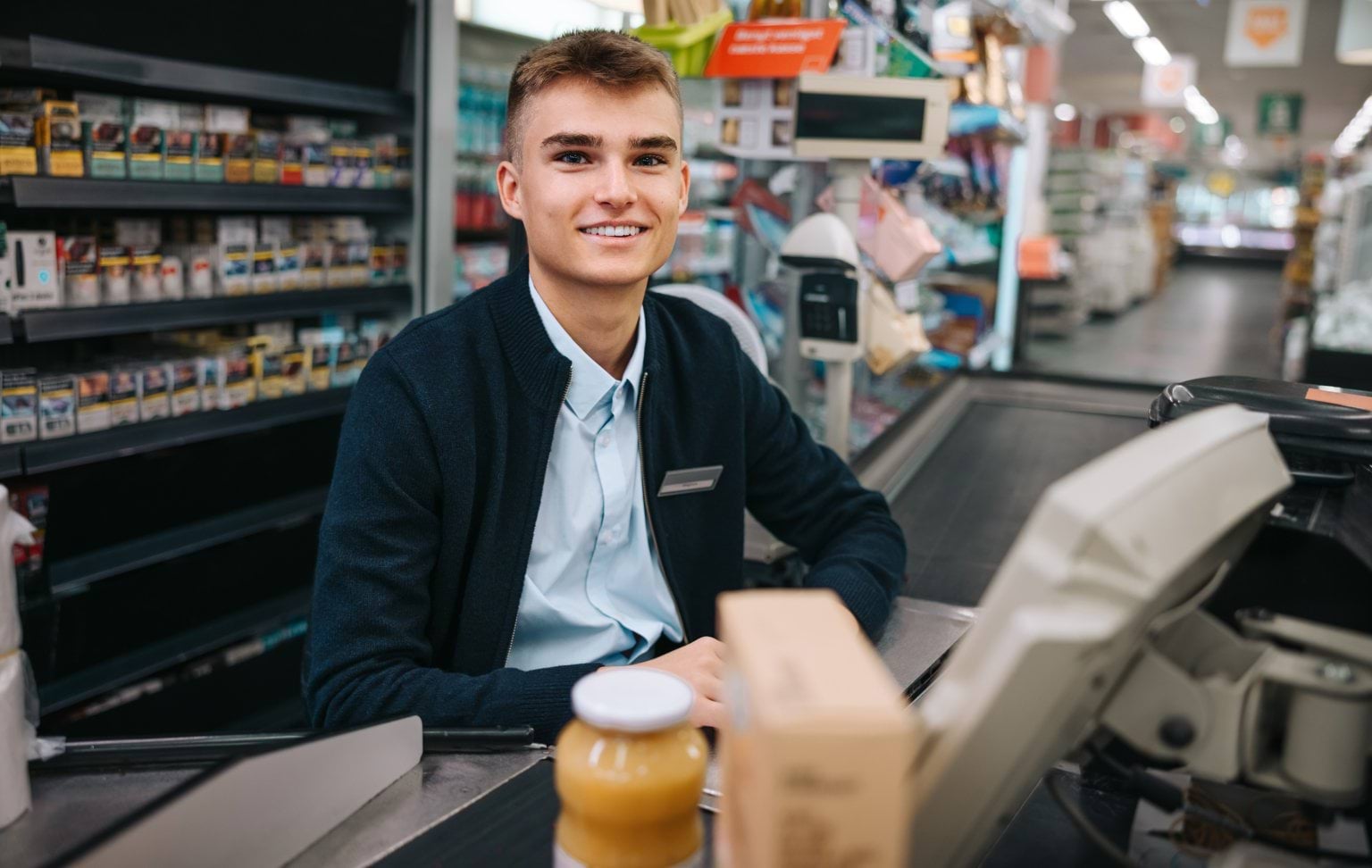 teenager working at cash register