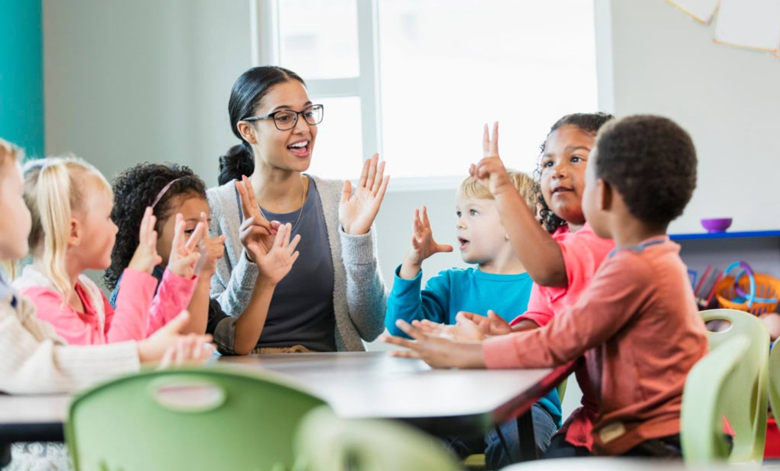 An educator, teaching a group of pre-school children