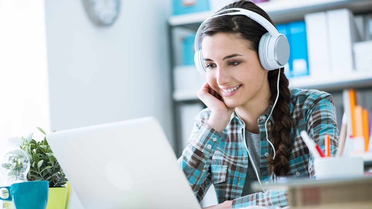 Student wear headphones using a laptop