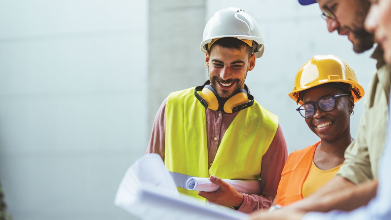 Group of people in high-vis clothing and hard hats Group of people in high-vis clothing and hard hats