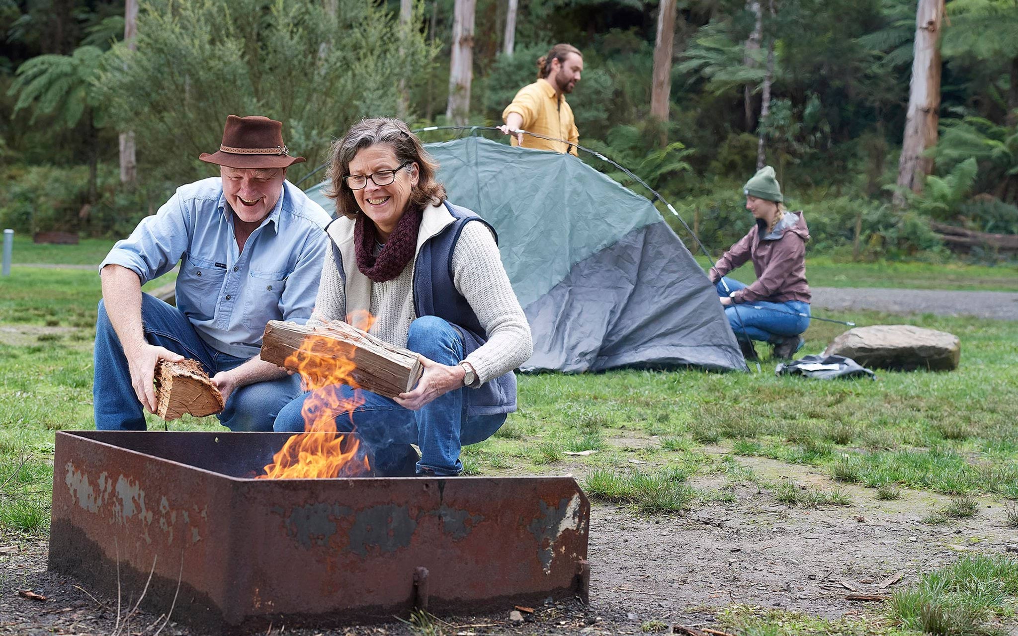 Campers building campfire Campers building campfire