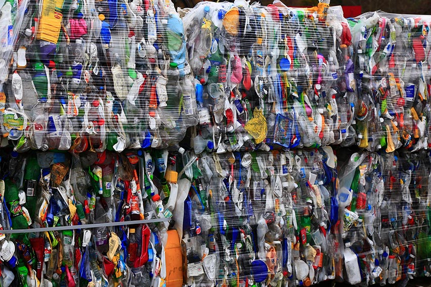 Bales of compressed plastic bottles and cans.