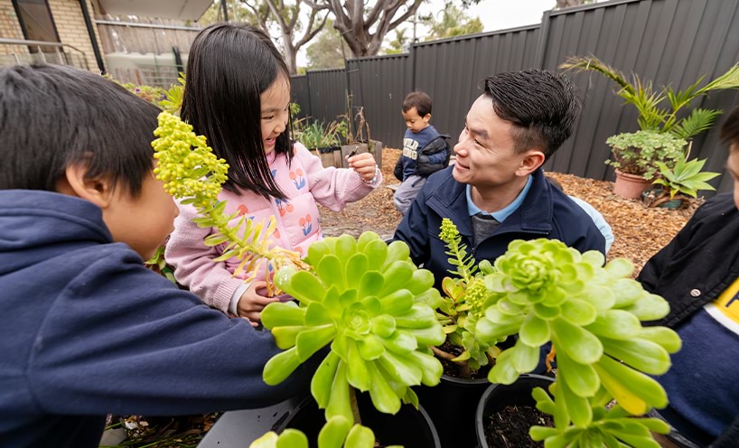 Child and educator talking in kindergarten playground