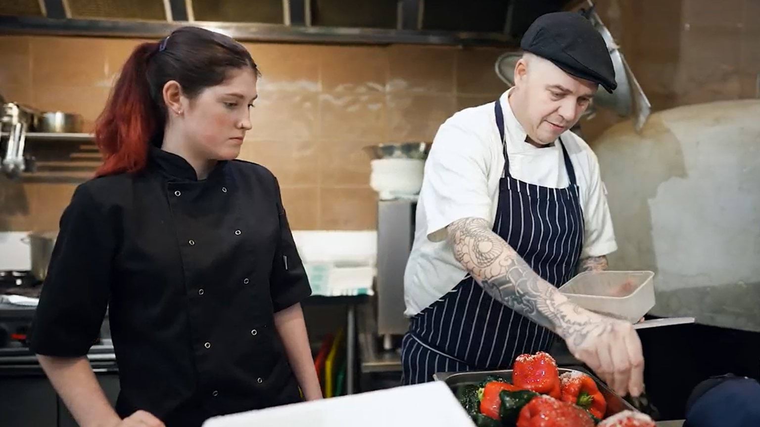 Employer satisfaction survey participant Michael and an apprentice chef in a commercial kitchen
