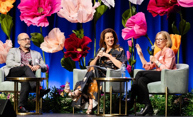 Conference panel members seated on stage