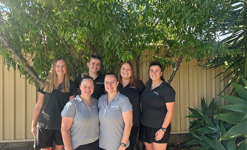 A group of Early Childhood educators standing under a tree