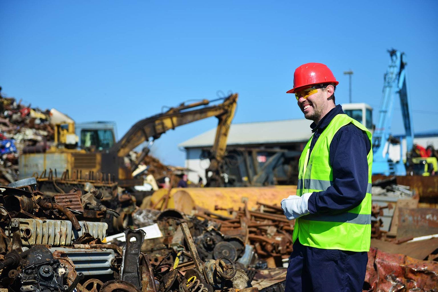 Man in PPE onsite at a metal recycling facility