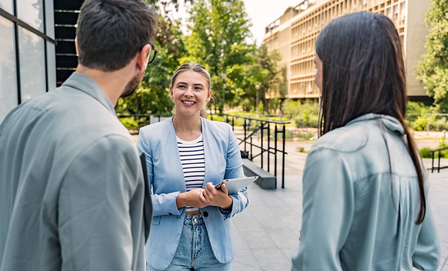 Group of business people talking outside an office building