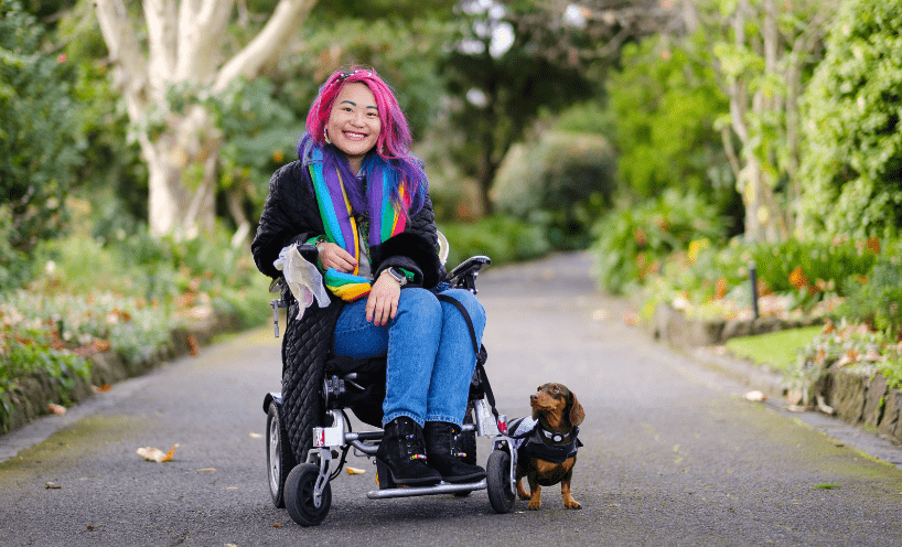 Akii and their assistance animal Arri, a miniature dachshund
