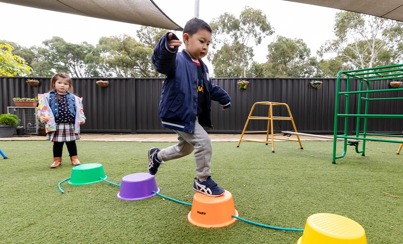 A child playing on a balancing equipment