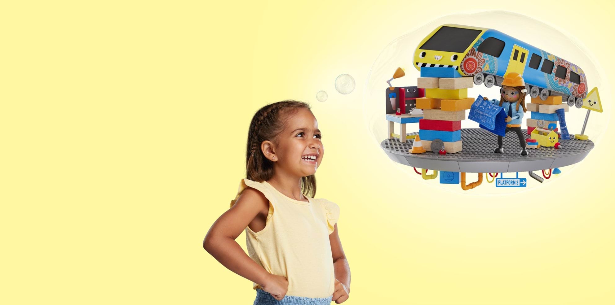 A young Koorie girl stands with hands on hips, smiling up at a thought bubble showing a 3D illustration of her repairing a train in a hard hat.