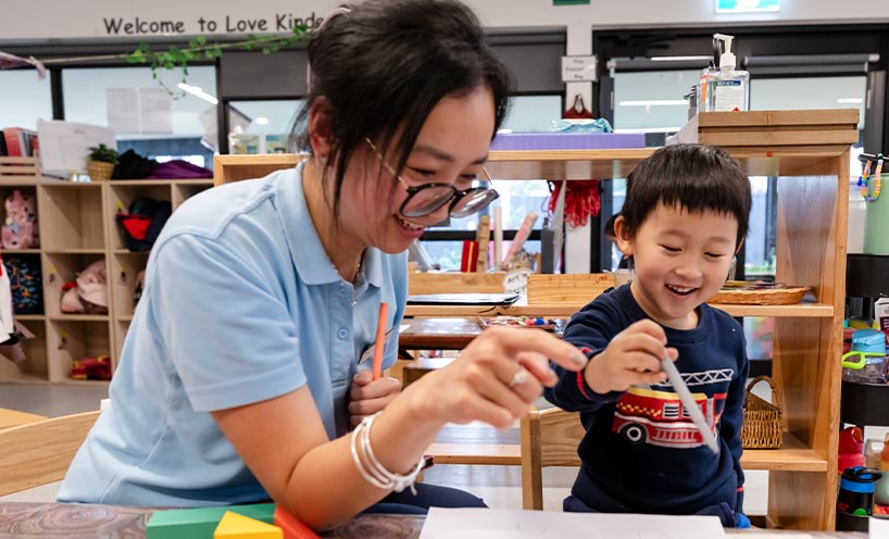 An educator assisting a child