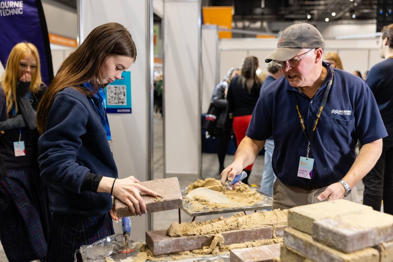 Female student laying bricks in tutorial