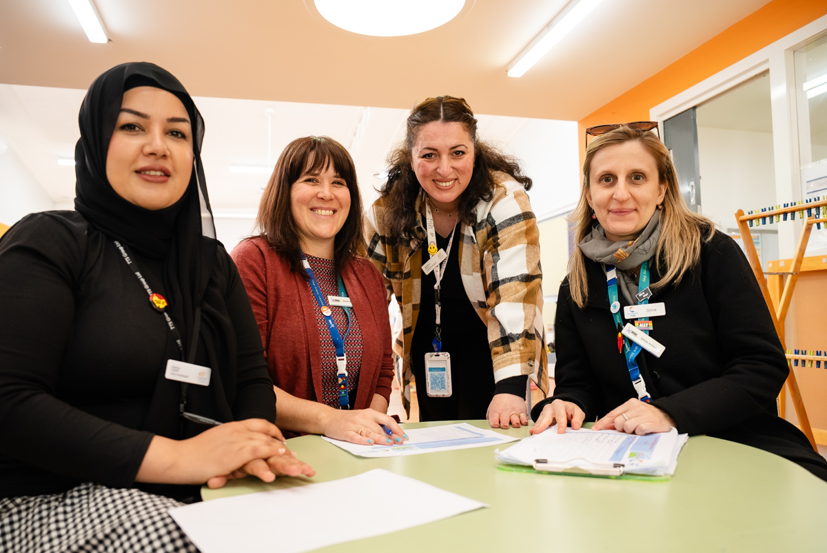 Staff from Hume Community Hub Playgroups sitting around a table.